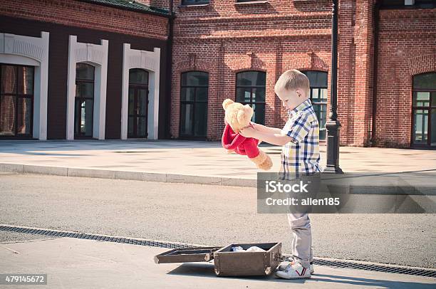 Kid Is Opening The Suitcase And Taking Teddy Bear Toy Stock Photo - Download Image Now