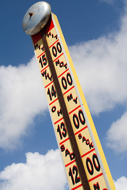 High Striker Strength Tester Ring the bell and win a prize.  Fairground strength tester with a cloudy blue sky background. A very bright and positive image. midway fair stock pictures, royalty-free photos & images