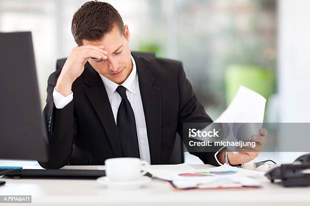 Businessman Reading Documents Stock Photo - Download Image Now - Adult, Adults Only, Beautiful People