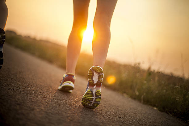 istock Runner athlete feet running on road 479146888