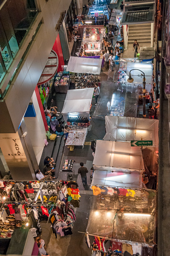 Bangkok, Thailand - May 20, 2011: An elevated view of market stalls and shoppers in Patpong, Bangkok. Patpong is a night market and red light area at the heart of Bangkok. Patpong caters primarily to tourists and is notorious for selling fake and copied good.