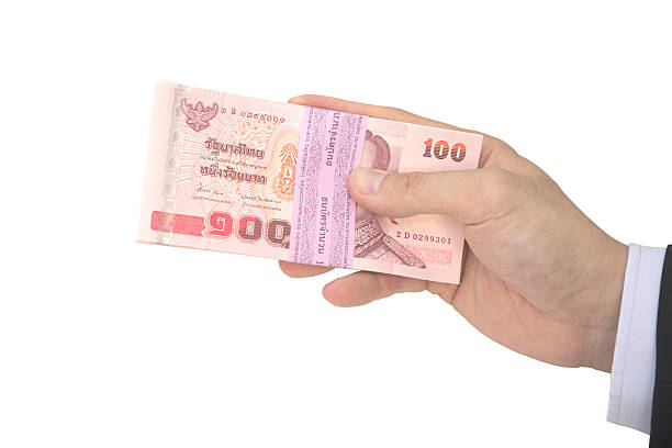 istock Thai male hand holding pack of baht notes 479150868