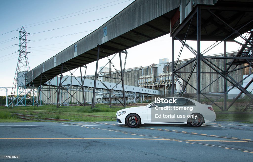 Mercedes-AMG C63 S Halifax, Nova Scotia, Canada - June 27, 2015: Mercedes-AMG C63 S parked in front of an abandoned processing plant on a gravel surface.  The Mercedes-AMG C63 S features a new 4.0-liter twin-turbo V-8 with 503hp. 2015 Stock Photo