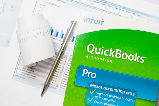 San Marcos, USA - July 5, 2011: QuickBooks box on graphs and pen. Quickbooks is an accounting software program created by INTUIT corporation. It is the most popular accounting software program for small business with over 90% market share.