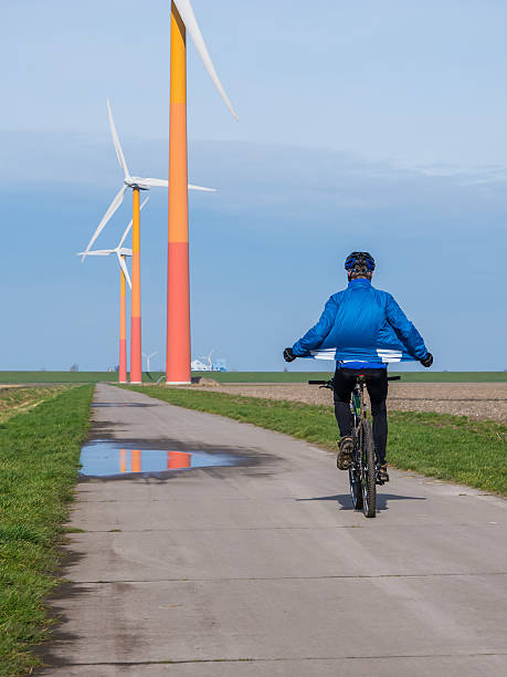 istock Mountain biker riding near wind turbine 479156285