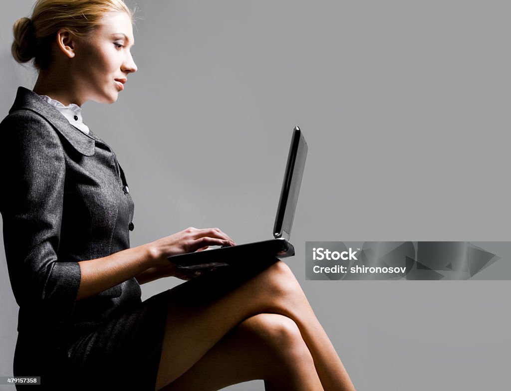 Working secretary Profile of serious businesswoman networking over grey background   Note to inspector: the image is pre-Sept 1 2009 2015 Stock Photo