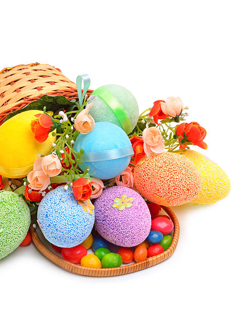 istock Easter colored plastic eggs, flowers and caramels in the basket 479159639