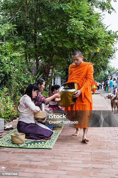 Monks Walk To Collect Alms And Offerings Stock Photo - Download Image Now - 2015, Adult, Alms