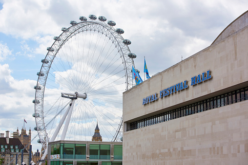 London, UK - June 15, 2015: Detail of the Royal Festival Hall building, in the South Bank, with London Eye in the background.