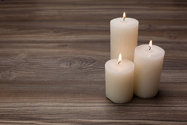 istock White candles on the board from oak 479162082