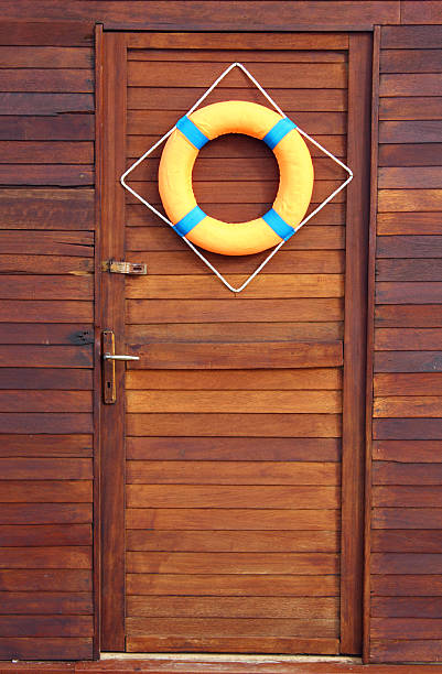 istock Life buoy hanging on wooden gate 479165032
