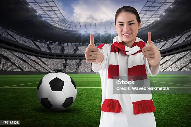 Football Fan In White Wearing Scarf Showing Thumbs Up Stock Photo - Download Image Now