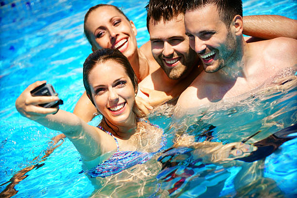 istock Friends taking selfies in swimming pool. 479165376