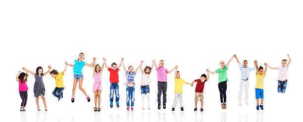 istock Cheerful kids holding hands and jumping together. Isolated on white. 479165380
