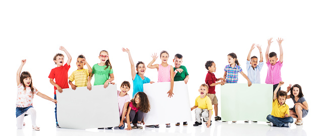 Large group of cheerful kids holding white papers for copy space. Isolated on white.