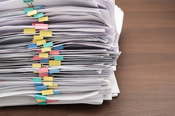 istock Pile of documents with colorful clips on desk stack up 479166014