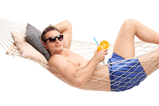 istock Man lying in a hammock and holding a cocktail 479169302