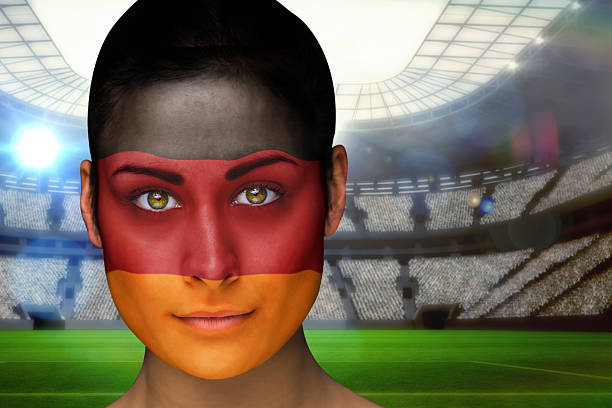 Composite image of beautiful germany fan in face paint against vast football stadium with fans in blue