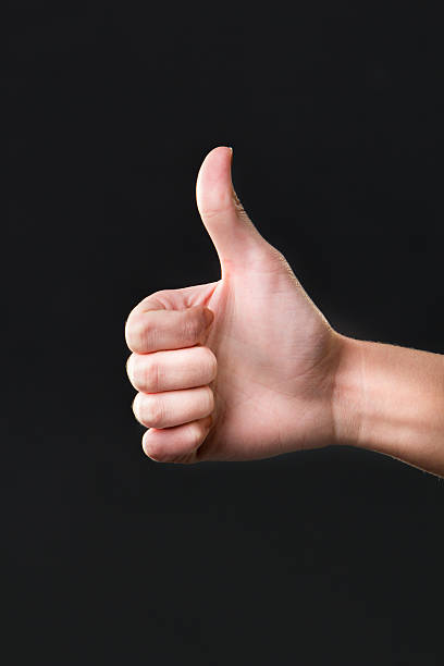 istock Thumb up female hand sign isolated on a dark background 479169866
