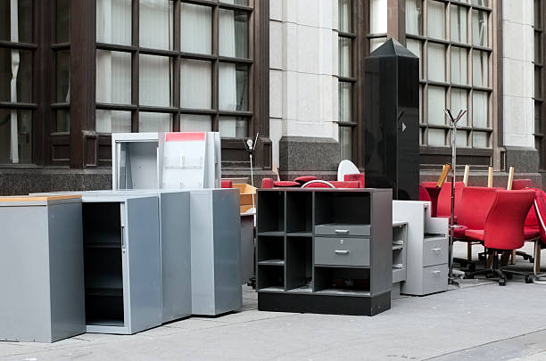 Office furniture stacked on a pavement