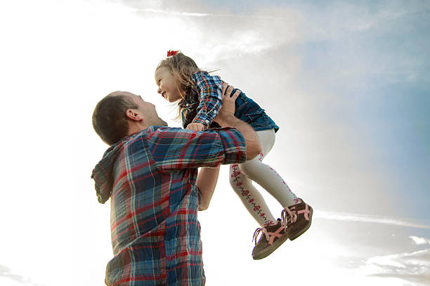 istock dad throws up the girl in the sky 479171082