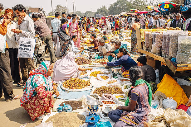New Dehli, India - March 10, 2014: Women selling seeds and spices at the Chadni Chowk spice markets in Delhi, India.