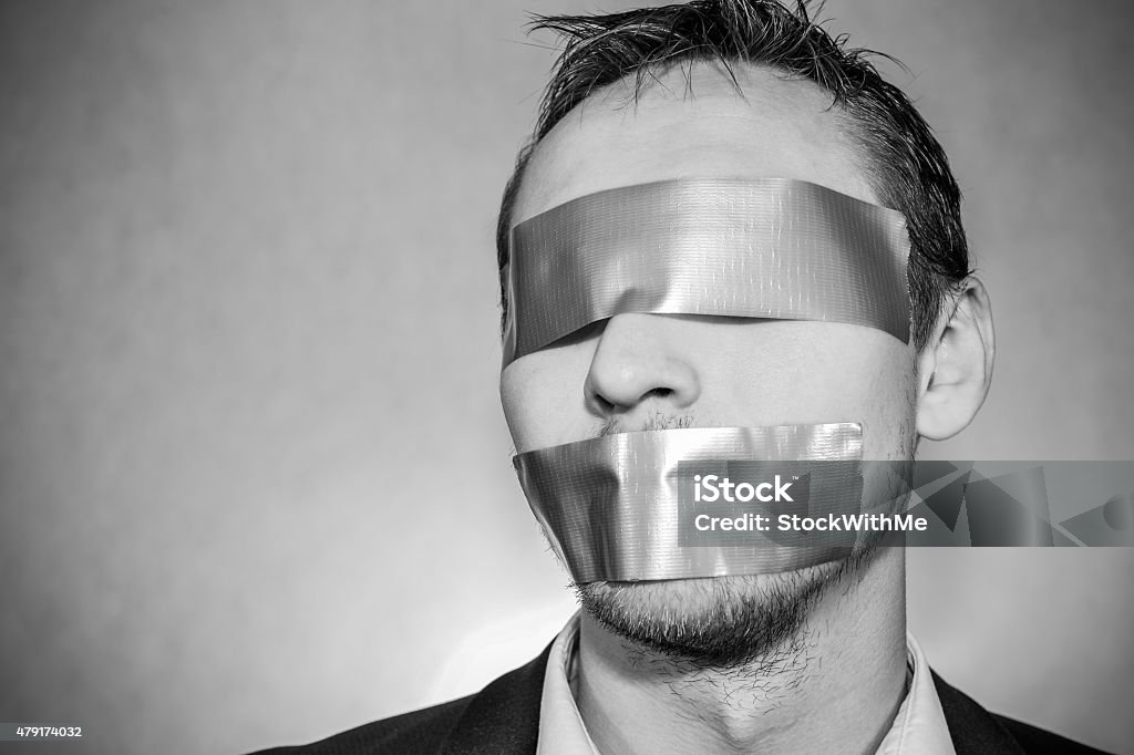 Man with sellotape Photo of a young man with sellotape covering his mouth 2015 Stock Photo