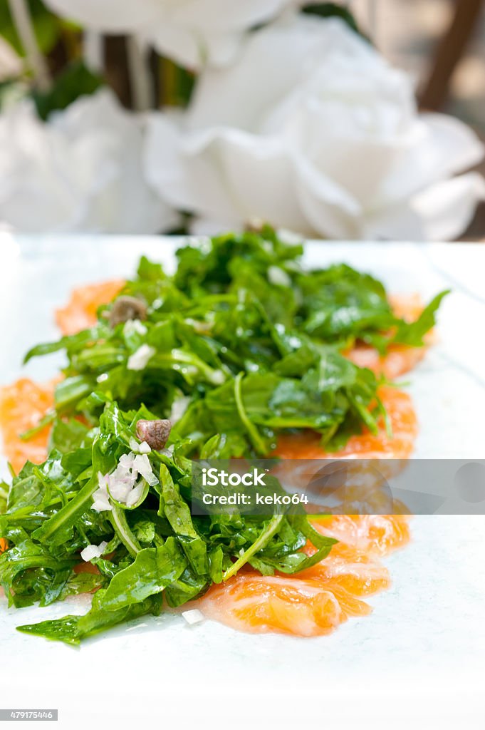 fresh salmon carpaccio fresh salmon carpaccio sushi sashimi with arugula rocket salad and caper on top 2015 Stock Photo