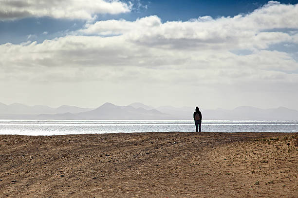 Lonely person at sandy seashore