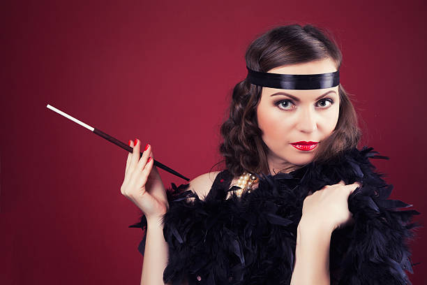 beautiful retro woman holding mouthpiece against wine red backgr beautiful retro woman holding mouthpiece against wine red background smoking women luxury cigar stock pictures, royalty-free photos & images