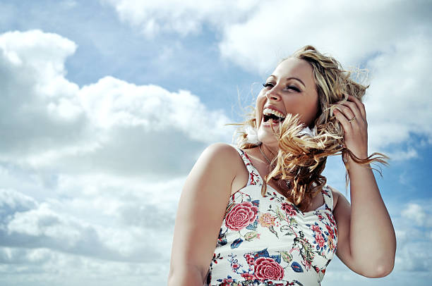 istock Laughing young woman and cloudy blue sky. 479185141