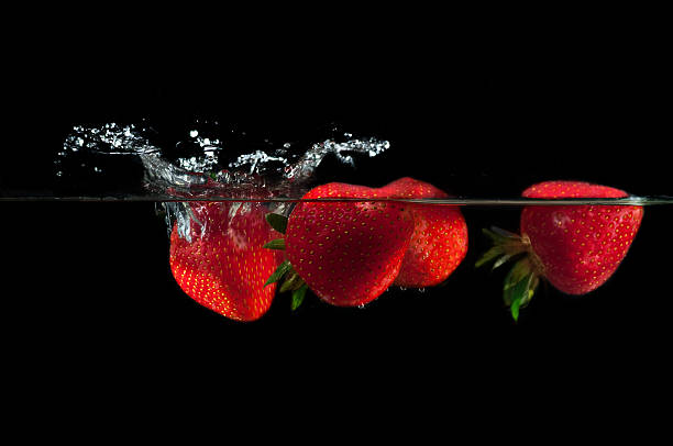 istock Strawberries splashing into water 479188258
