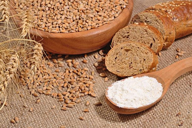istock White flour in a wooden spoon, wheat and bread 479190474