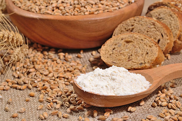 istock White flour in a wooden spoon, wheat and bread 479190484