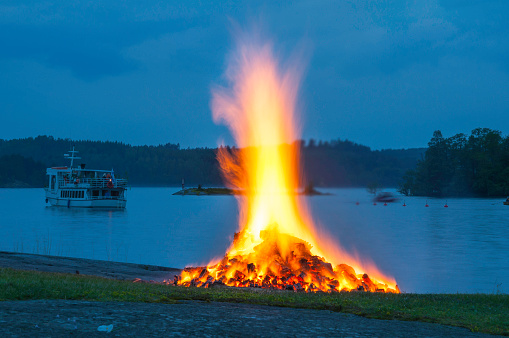 Bonfire burning during summer solstice celebrations in Riihisaari, Savonlinna, Finland.