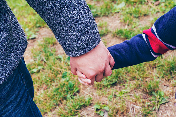 istock father and son holding hands 479191570