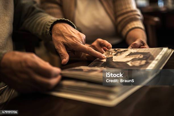 Close Up Of Senior People Remembering Their Old Photos Stock Photo - Download Image Now