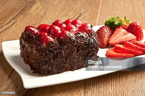 Piece Of Chocolate Cake With Icing And Fresh Berry Stock Photo - Download Image Now - Baked Pastry Item, Bakery, Baking