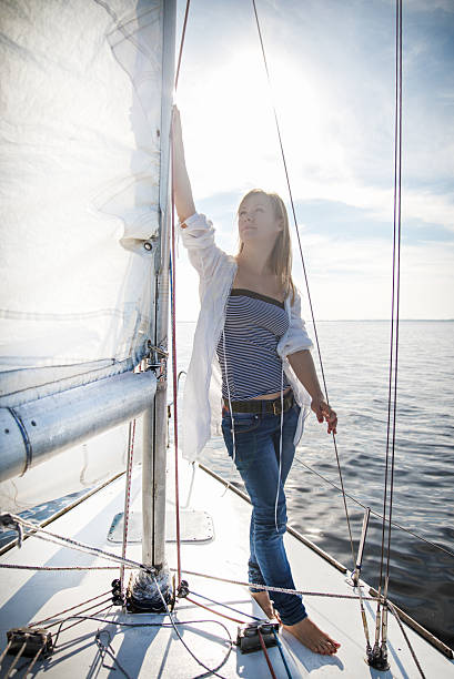 istock woman staying on sailboat 479193675