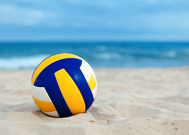 ball is lying on sand near ocean