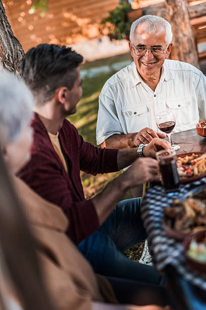 istock Smiling senior man communicating with his family during lunch. 479194668