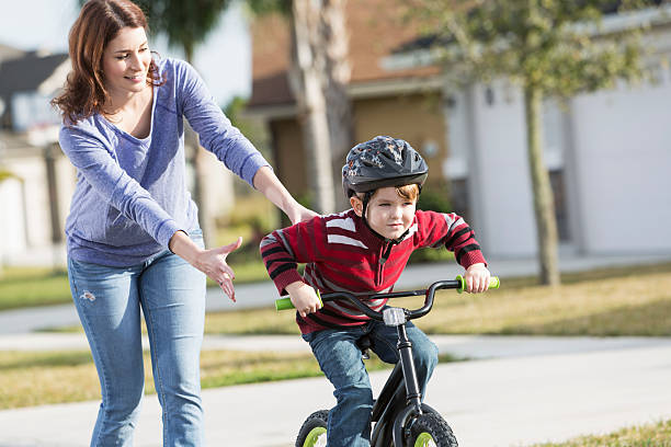 istock Little boy with mother, learning to ride a bicycle 479194805