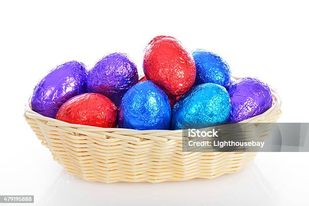 Wicker Basket Of Multi Coloured Chocolate Easter Eggs White Background Stock Photo - Download Image Now