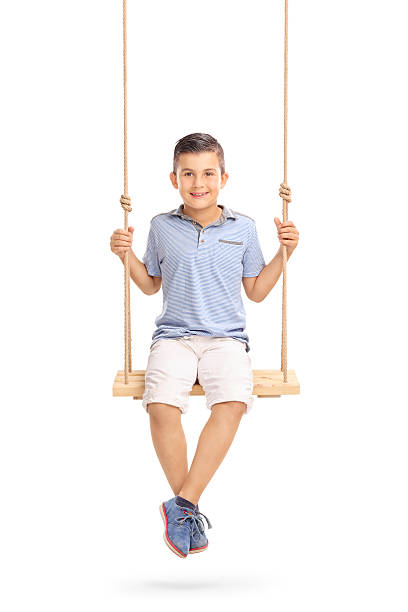 istock Joyful little boy sitting on a swing 479196244