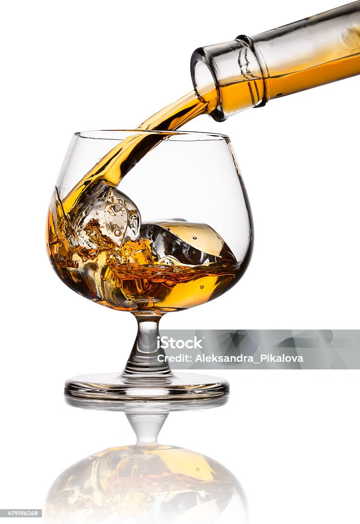 Whiskey Pouring whiskey in glass with ice isolated on white 2015 Stock Photo