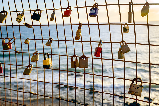 Rusty love locks hanging on the fence as a symbol of loyalty and eternal love