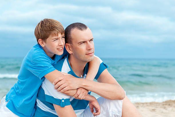 istock Father and son sitting on sea 479197873