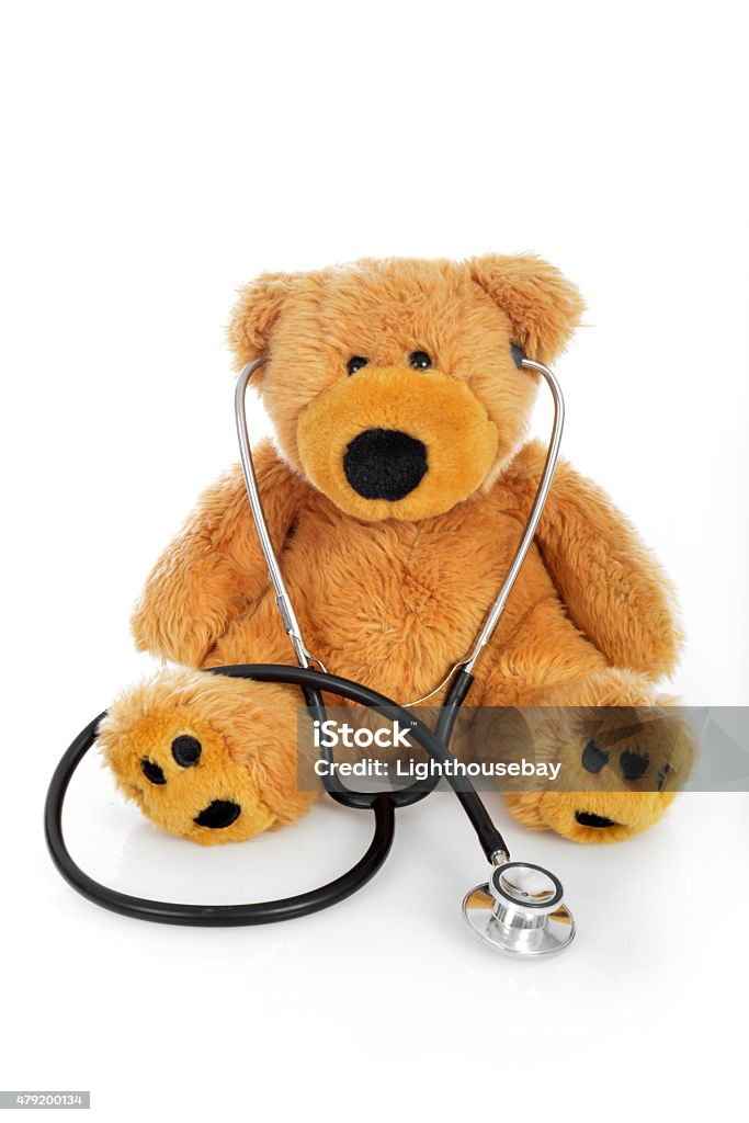 Teddy bear with a stethoscope on white background One teddy bear with a stethoscope on white background. Vertical image. Pediatrician Stock Photo