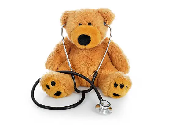 Photo of Teddy bear with a stethoscope on white background
