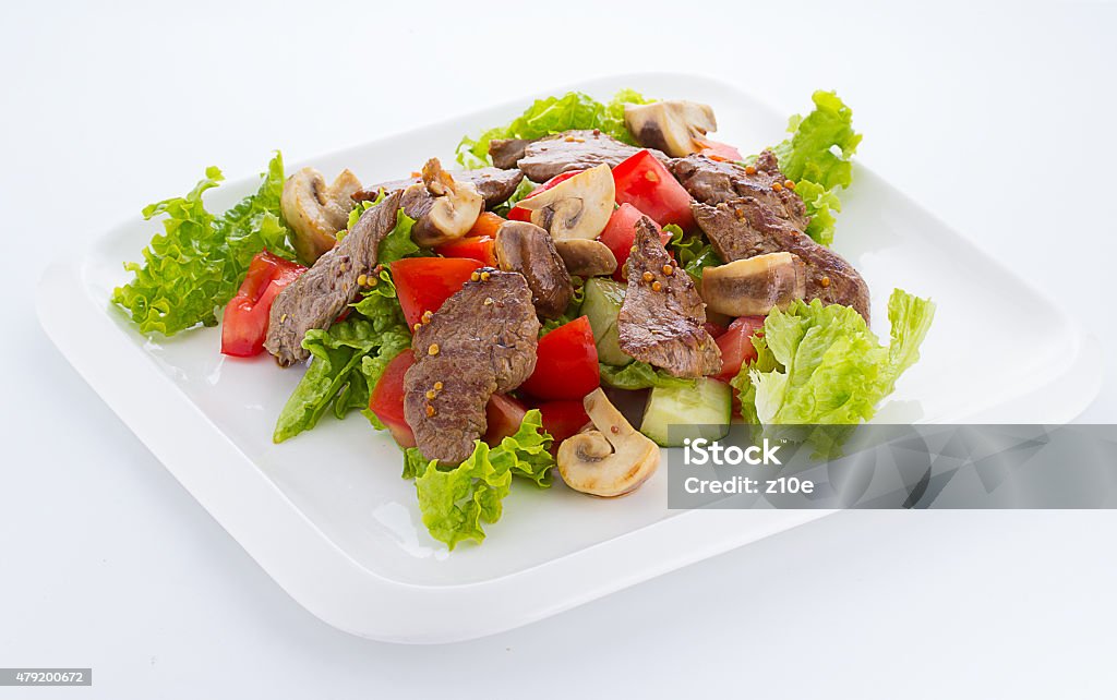 Vegetable salad with mashrooms and meat isolted on white background 2015 Stock Photo